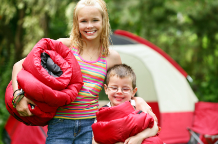 blond girl and little boy camping