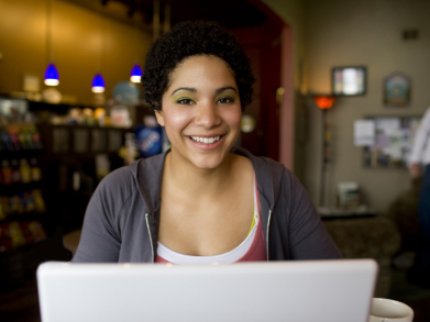 mum at work on laptop in coffee shop